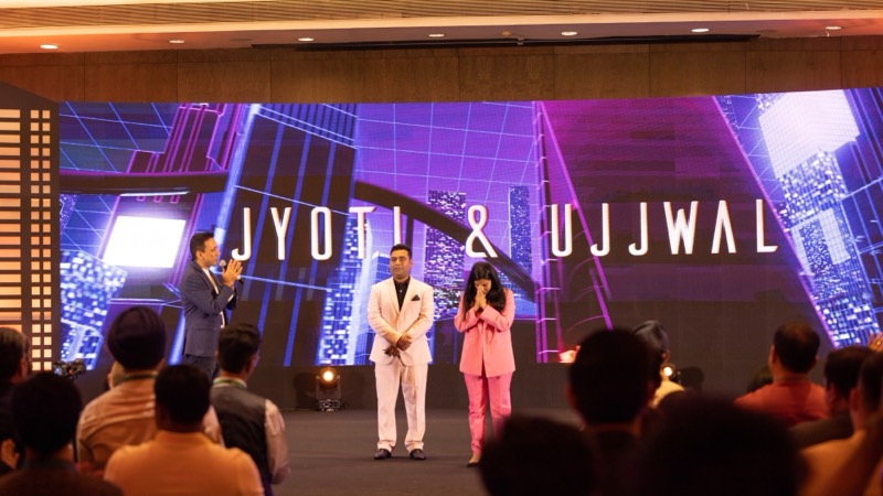 Ujjwal Abhishek and Dr. Jyoti on stage in front of an audience